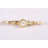 A lady's rolled gold Regency manual wind bracelet watch with silvered dial and Arabic and baton