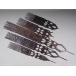 Five Tanazanian carved ebony ceremonial combs (largest 31 1/2" long)