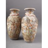 A pair of Japanese Satsuma vases with panelled battle and figures in a landscape decoration and