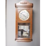 An early 20th century eight-day Westminster chiming drop dial wall clock with silvered dial and