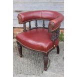 A 19th mahogany tub shape desk elbow chair, upholstered in a red leather, on reeded supports