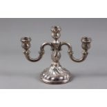 A Scandinavian white metal three-light candelabra with scrolled and spiral fluted design, on