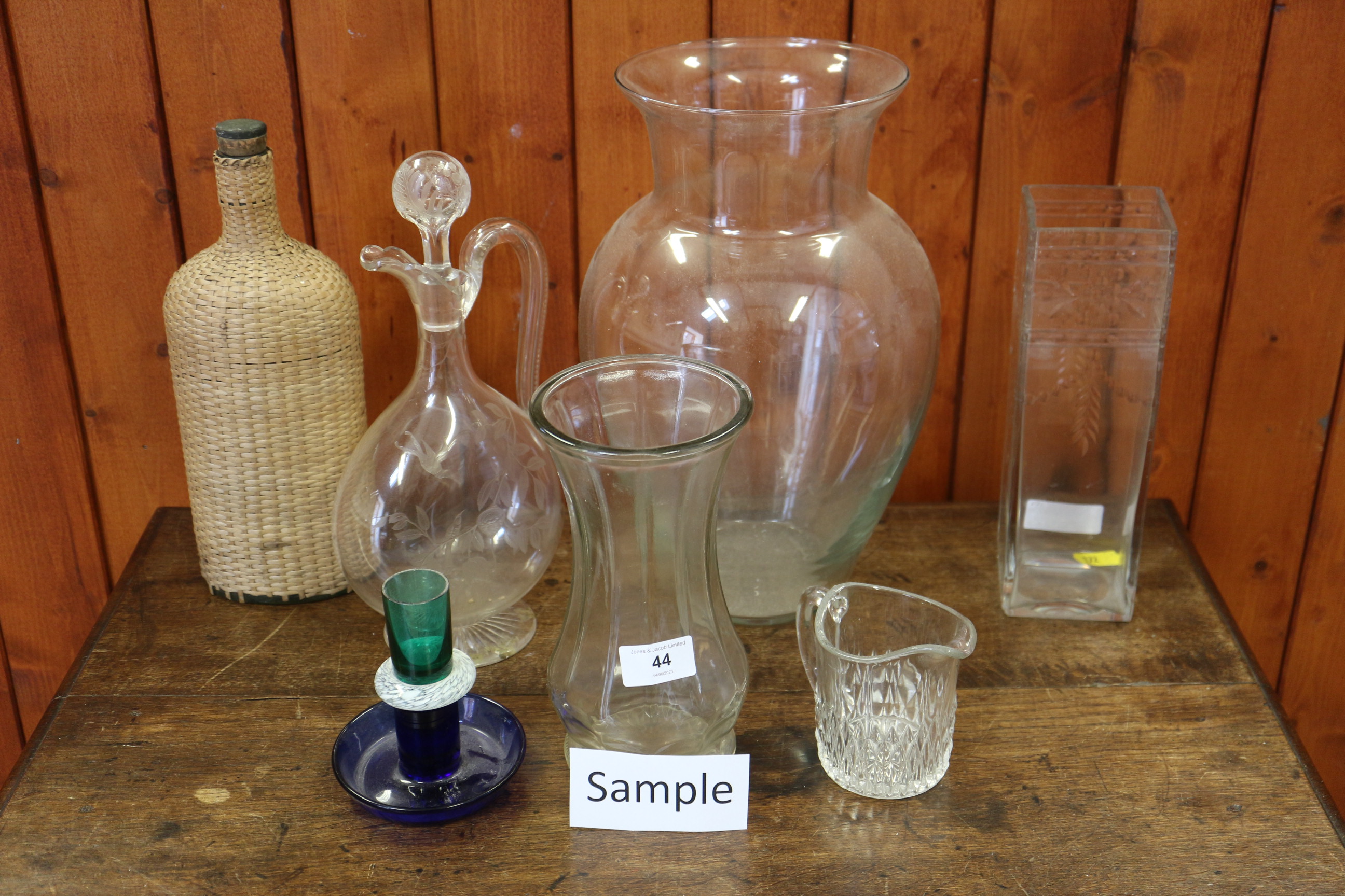 A quantity of mostly clear glass vases, jugs and bowls, including a jug and stopper with etched