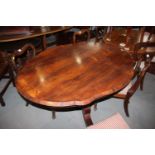 A 19th century Continental rosewood serpentine shape tilt top loo table, on triform column and splay