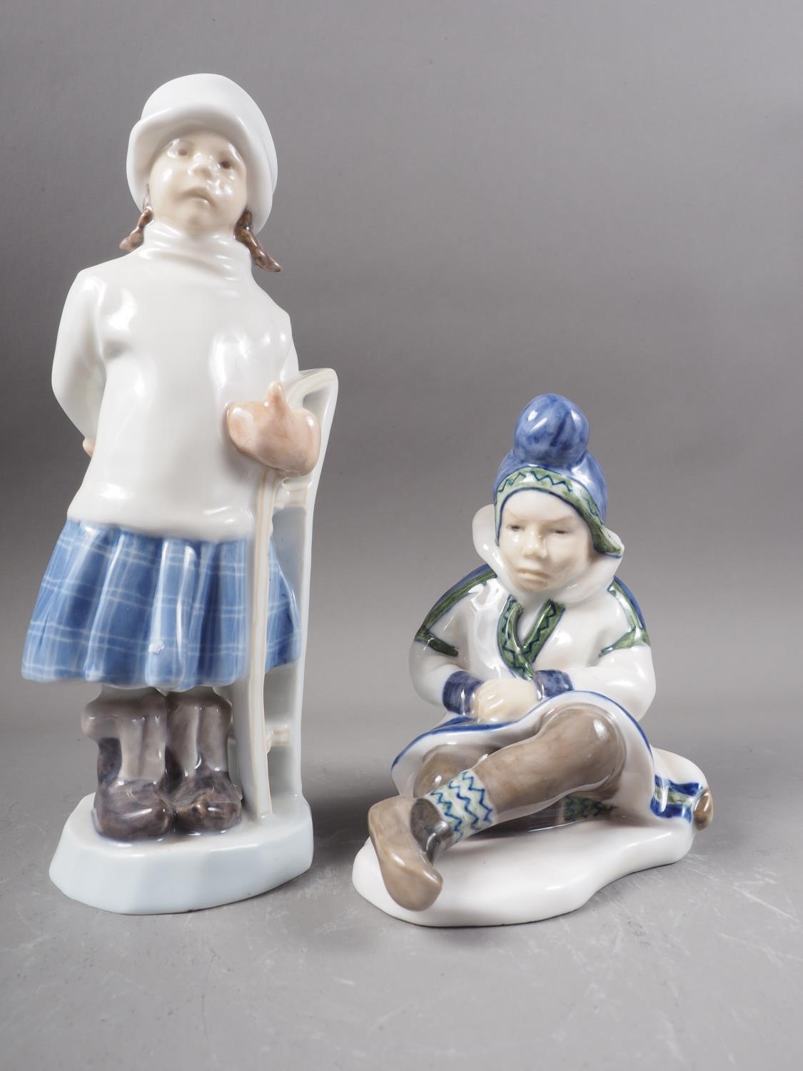 Two Royal Copenhagen figures, girl with sled (1382) and Greenland girl (1398)