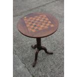 A 19th century rosewood and satinwood games table, on turned column and carved tripod splay