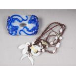 A Chinese bi-colour carved brooch and a jade and silk necklace