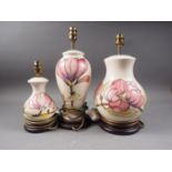 Three Moorcroft "Magnolia" table lamps, various shapes, tallest 15" high