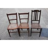 A pair of cane seat bedroom chairs and a similar chair
