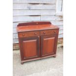 A 19th century ledge back sideboard, fitted two drawers over cupboard enclosed two panel doors, on