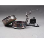A pair of silver plated wine bottle coasters and a table lighter with stand, mounted golfer, 6 3/