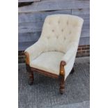 A 19th century Scandinavian armchair, button upholstered in a floral figured fabric, on turned and