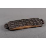 An African ebony mancala board, 19 1/2" wide