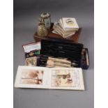 A quantity of early 19th century postcards, an autograph album, various medals and other items