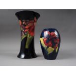 A William Moorcroft orchid/iris pattern flared rim vase, 8" high, and another smaller similar