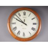 A French eight-day oak cased wall clock with painted dial and Roman numerals, 20 1/2" dia