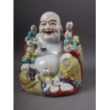 A Chinese figure of a Buddha and five followers, two seal marks to base, 10" high