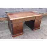 A partners early 20th century mahogany double pedestal desk with tooled lined leather top, inverse