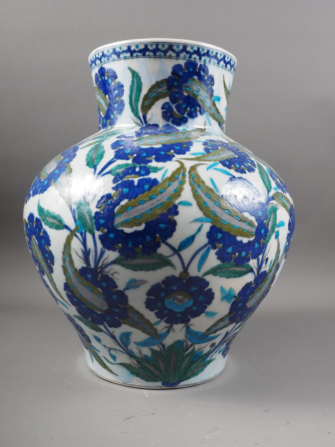 An Isnik bulbous vase of traditional floral design in shades of blue, 15" high