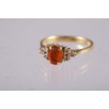 An 18ct gold, fire opal and diamond ring, size 'L', 2.8g