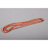 A red coral two-strand necklace with white metal clasp, 17 1/4" long overall, 31.2 grams