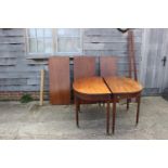 A late 19th century mahogany dining table with three extra leaves, on square taper supports and