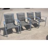 A set of four metal frame garden elbow chairs