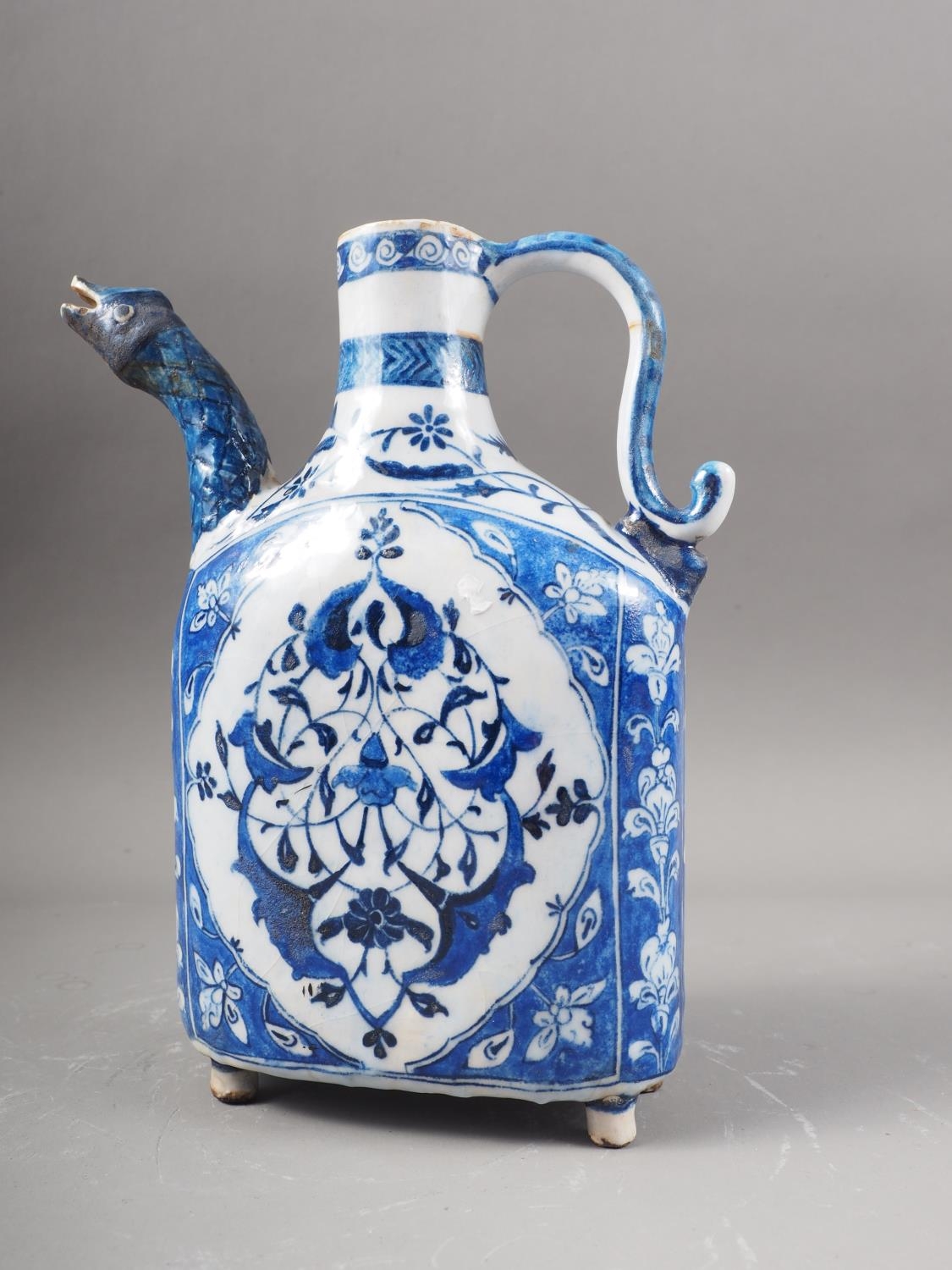 An Isnik blue and white decorated jug with animal head spout, 9 1/2" high