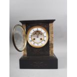 A black slate and marble mantel clock with eight-day striking movement, engraved decoration, white