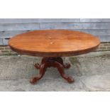 A 19th century mahogany oval tilt top dining table, on turned column and tripod splay support, 60" x