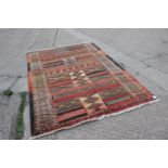 A modern geometric rug in shades of orange, yellow, red and natural, 93 1/2" x 66" approx