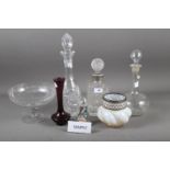 An assortment of glassware, including four decanters and stoppers, an art glass paperweight,