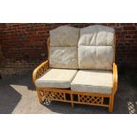 A rattan loggia settee with loose seat and back cushions, and aÿbrass and white painted bedhead, 37"