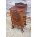 An early 20th century carved mahogany coal purdonium with ledge back, on carved cabriole claw and