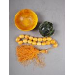 An amber composition bowl, a set of similar prayer beads and a jade bowl (damages)