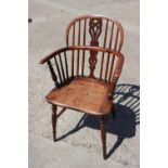 A 19th century yew splat bow back elbow chair with elm panel seat, on fruitwood turned and