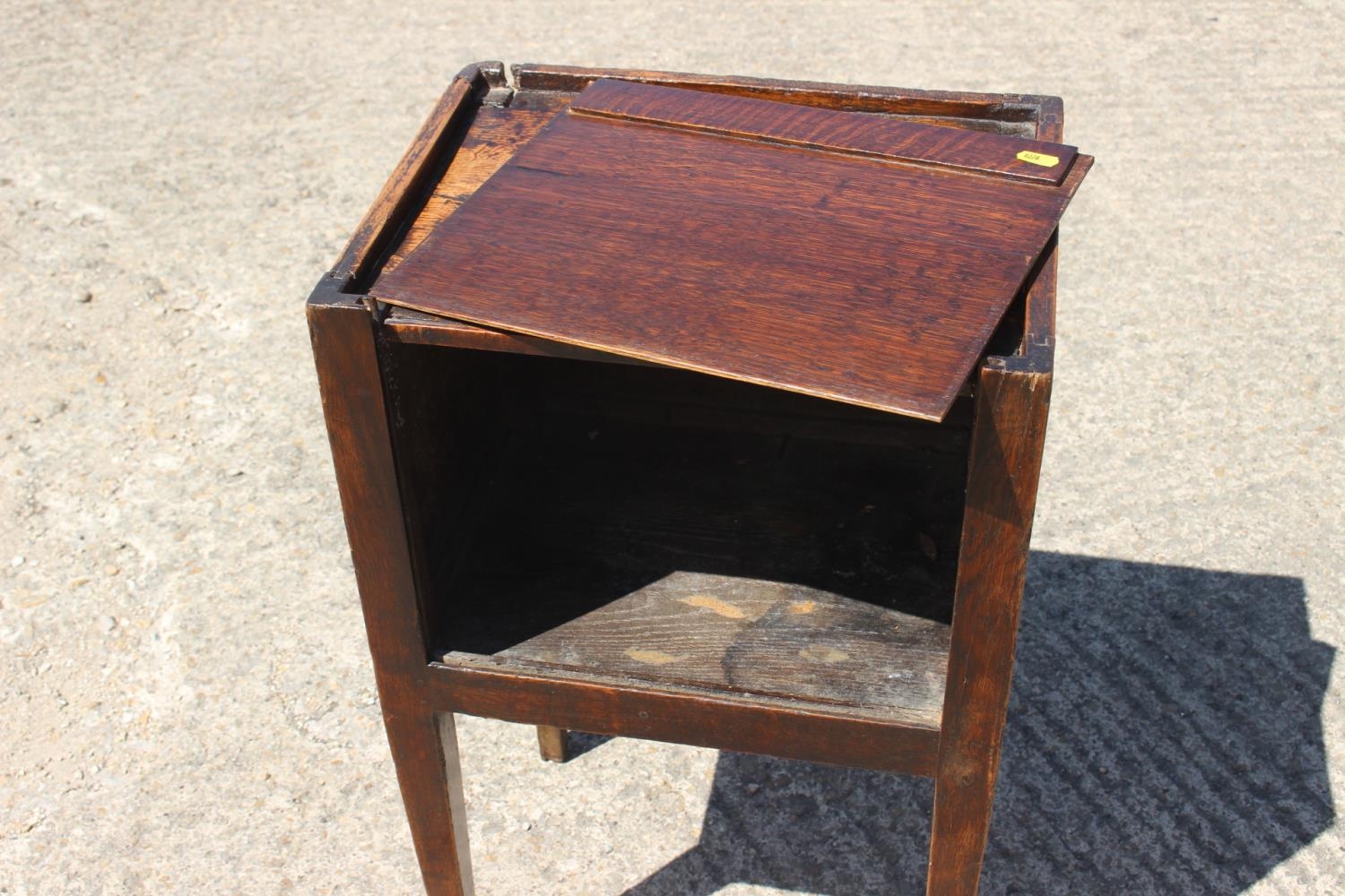 An early 19th century provincial oak tray top bedside cupboard with lift up front, on square taper - Image 2 of 2