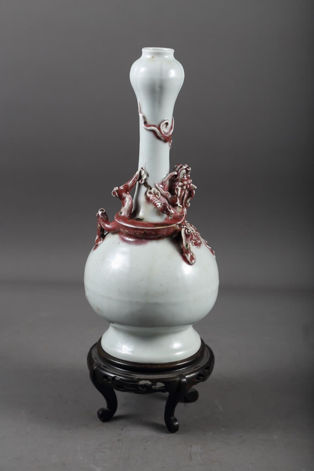 A Chinese pale glazed bottle neck vase with relief iron oxide coloured dragon decoration, 11 3/4"