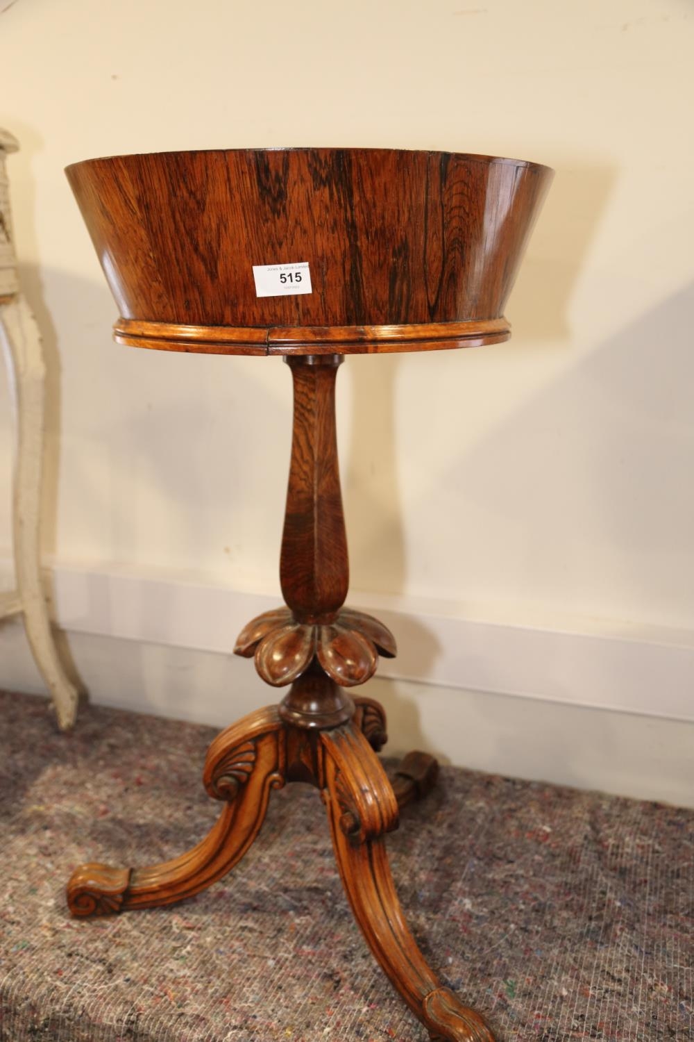 A William IV rosewood circular top zinc lined jardiniere, on faceted column and carved, tripod