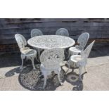 A white painted aluminium garden table with six matching chairs