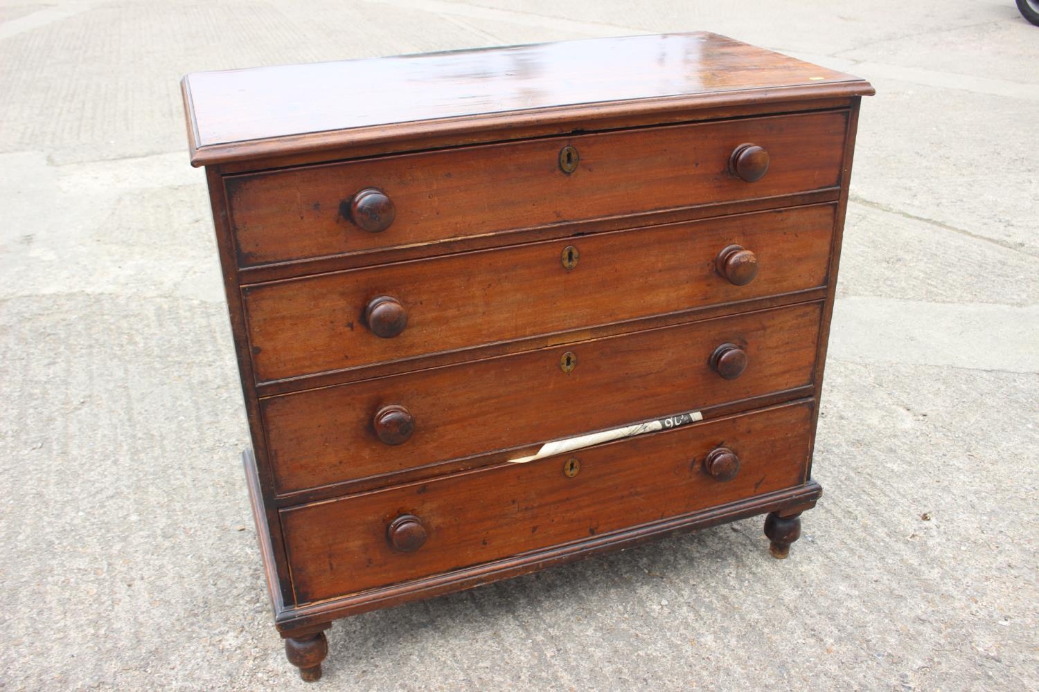 A 19th century mahogany chest of four long graduated drawers with knob handles, on turned