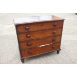 A 19th century mahogany chest of four long graduated drawers with knob handles, on turned