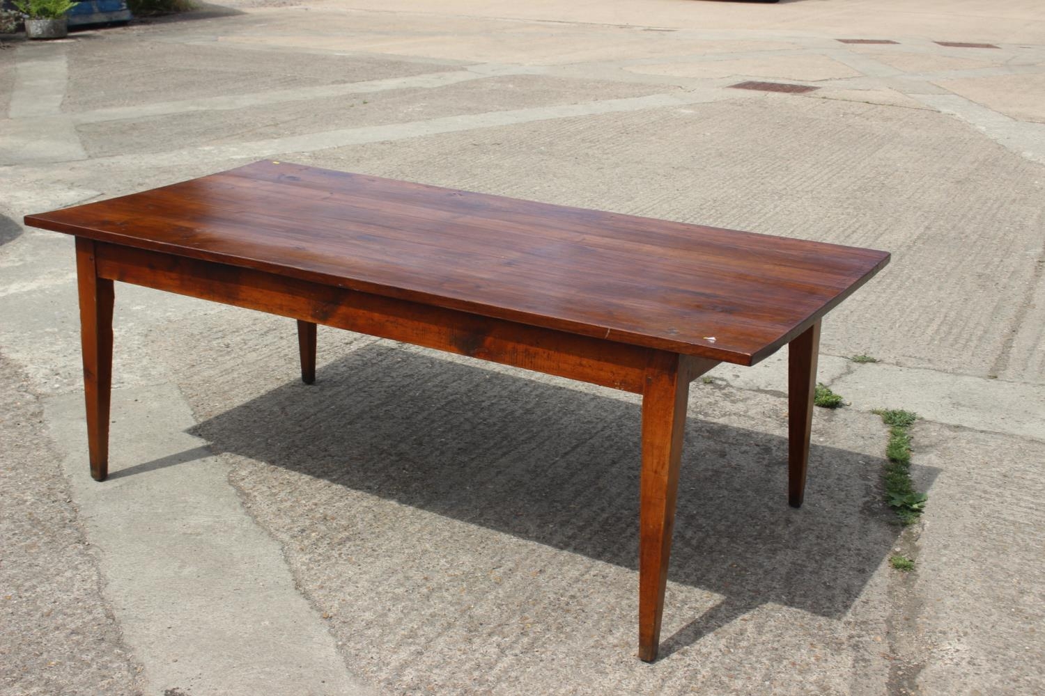 A 19th century French cherrywood farmhouse dining table, fitted one frieze drawer, on square taper