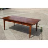 A 19th century French cherrywood farmhouse dining table, fitted one frieze drawer, on square taper