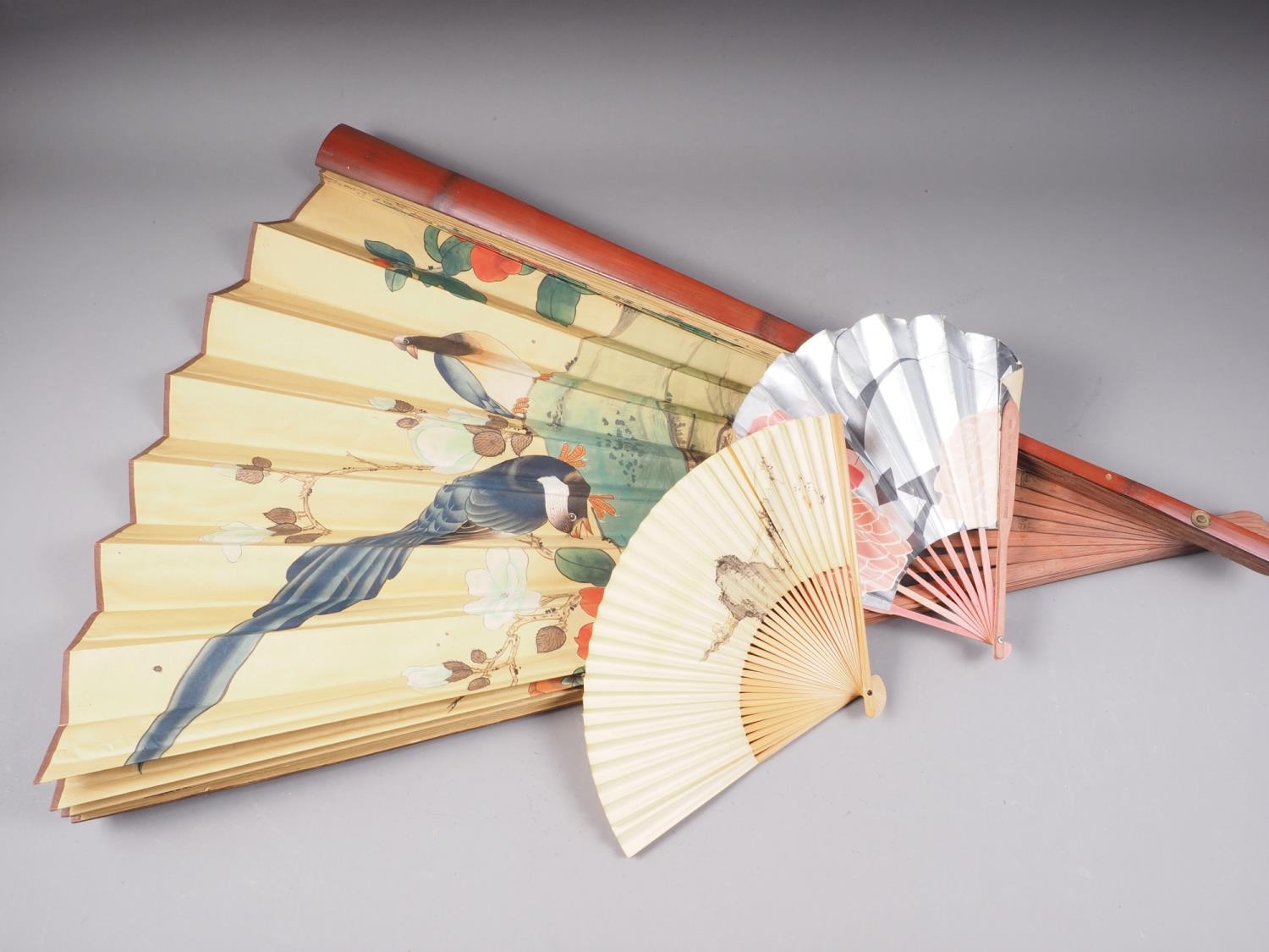 A Japanese fan with painted bird and flower decoration, 34 3/4" high, and two other similar