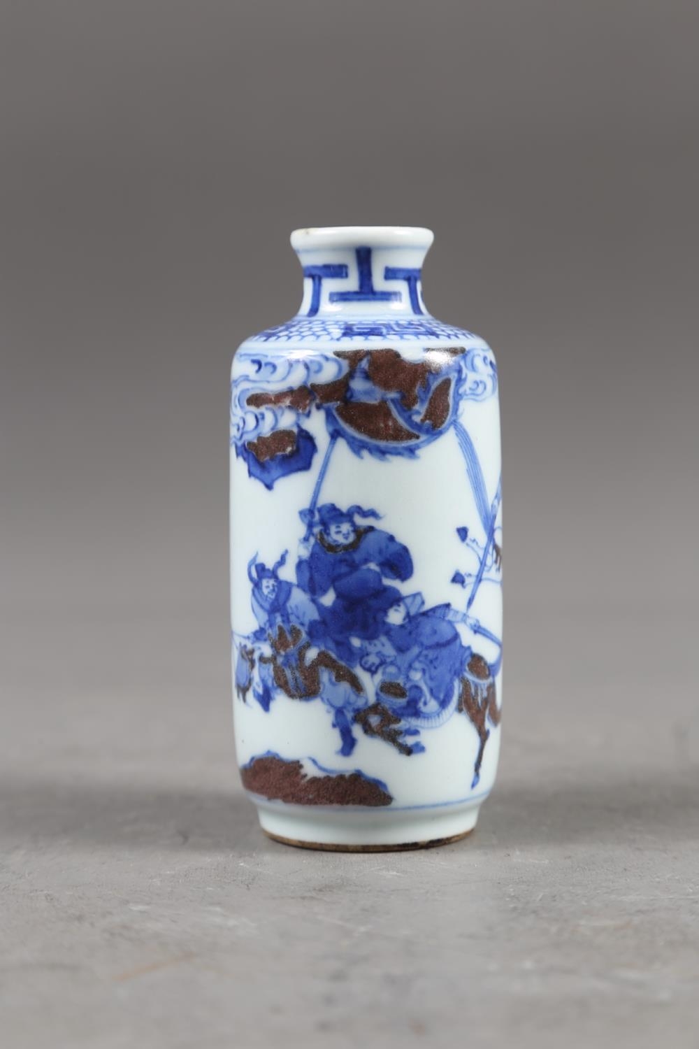 A Chinese blue, white and iron oxide glazed cylindrical miniature vase with warriors in a - Image 9 of 13