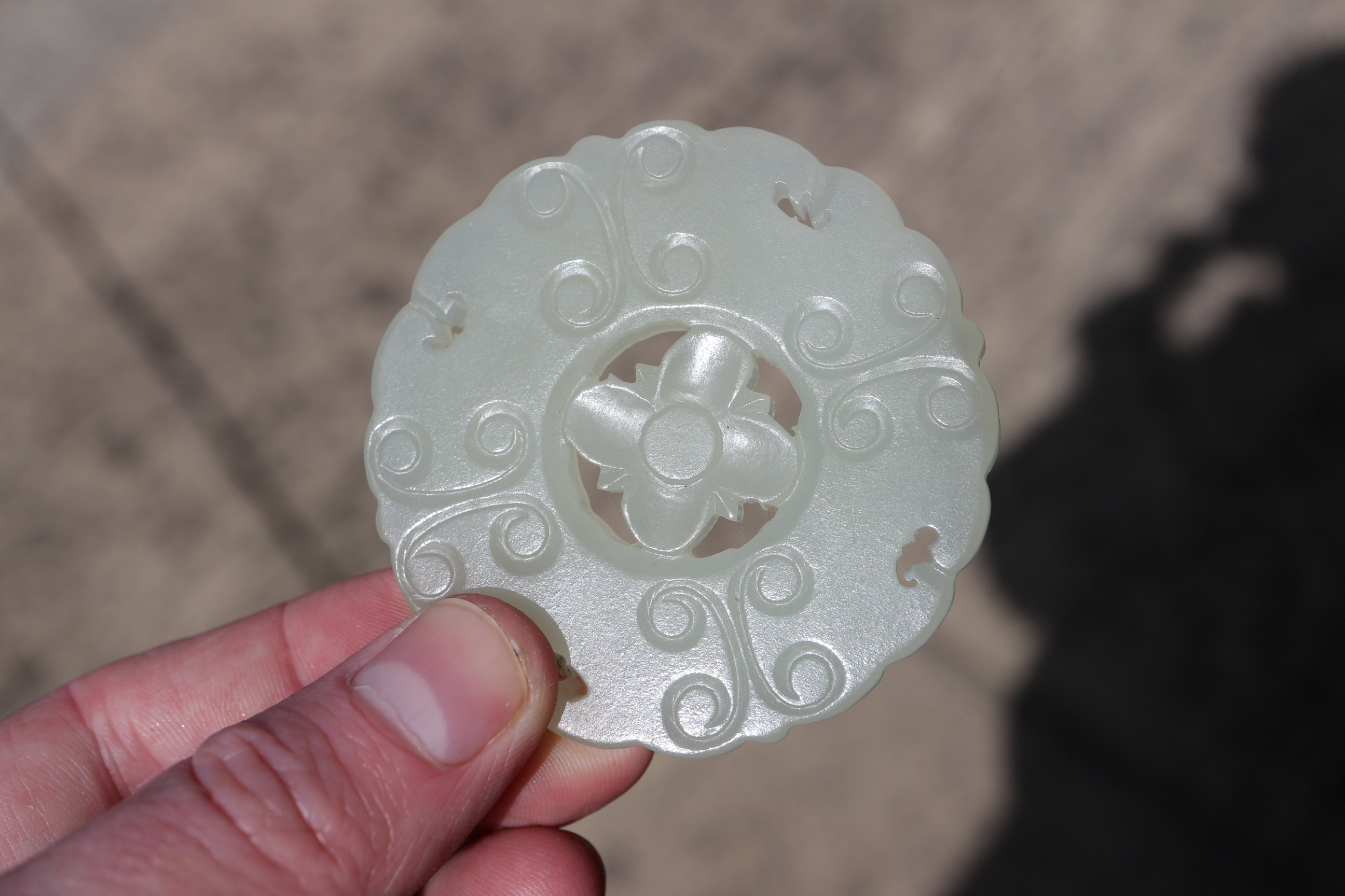 A Chinese carved pale jade pendant, 2 1/4" dia, with stand - Image 13 of 14