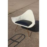 A 1950s shaped metal frame armchair, on splay supports