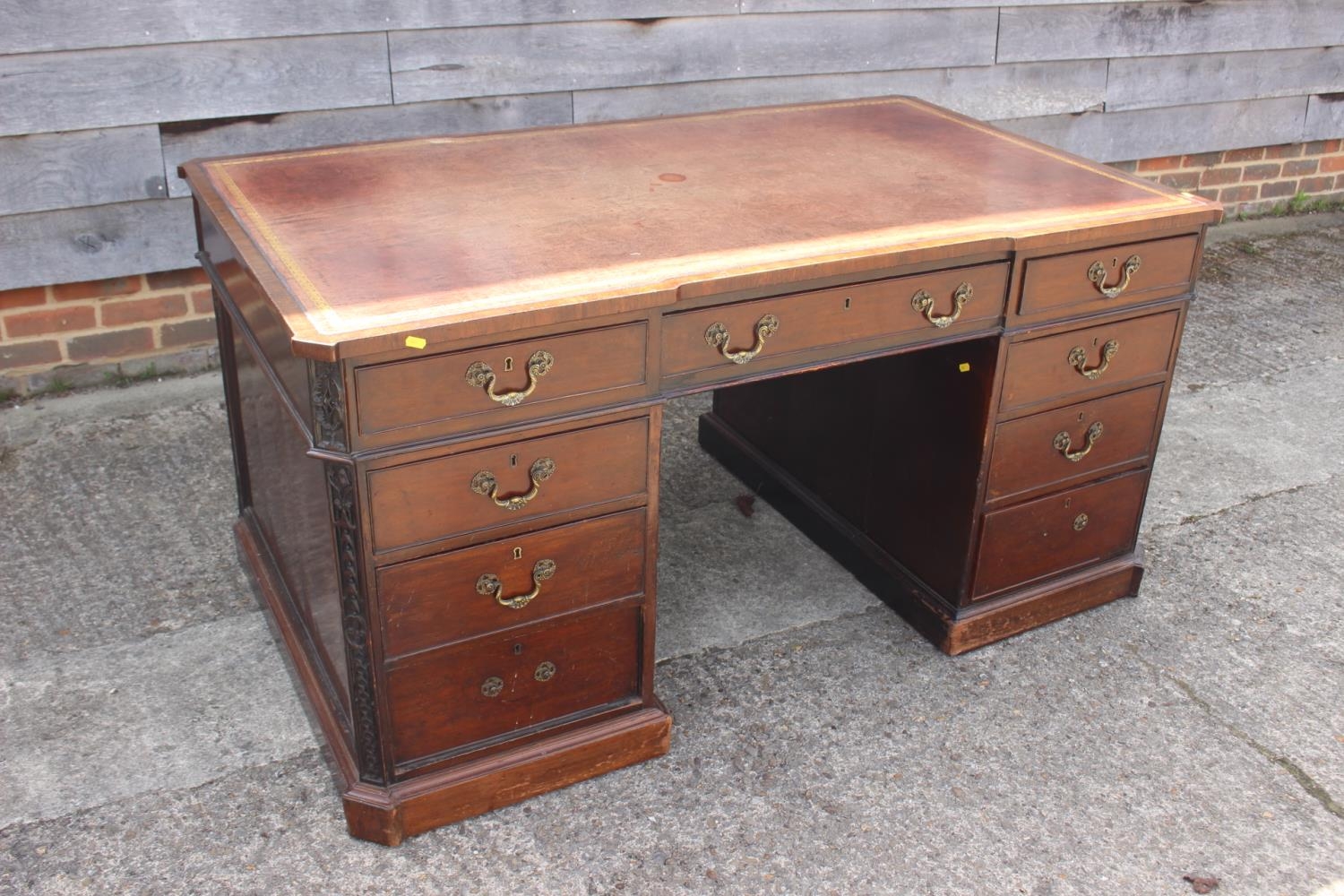 A partners early 20th century mahogany double pedestal desk with tooled lined leather top, inverse