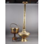 An embossed brass vase with long tapering neck and bulbous body, 42" high, a jam pan, a trivet and a